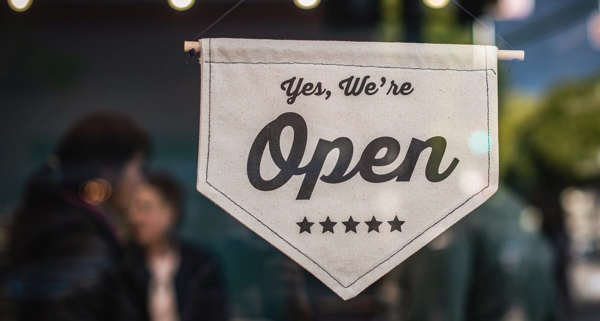 what-you-should-know-about-the-reopening-phases-of-new-york-city We are open sign in business window