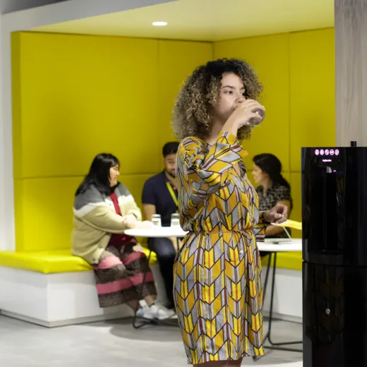 girl drinking from carbon8 v2 water dispenser