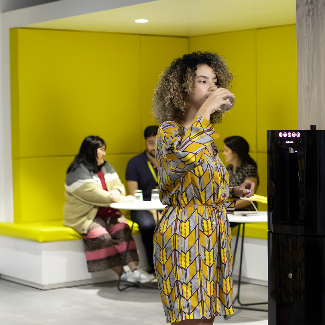 girl drinking from carbon8 v2 water dispenser