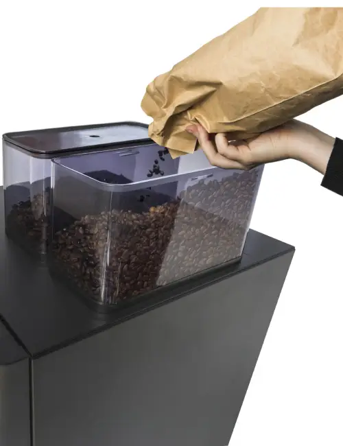 filling coffee beans in coffee maker